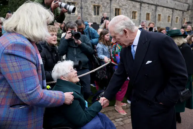King Charles greets well-wishers as they leave St. George's Chapel, in Windsor Castle