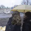People bring candles and flowers at the school in Finland