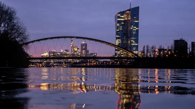 The European Central Bank is reflected in the river in Frankfurt, Germany