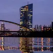 The European Central Bank is reflected in the river in Frankfurt, Germany
