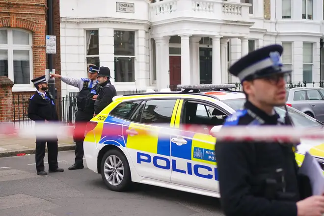 Police officers at the scene in Comeragh Road, West Kensington, west London, after a man was shot dead on Easter Monday