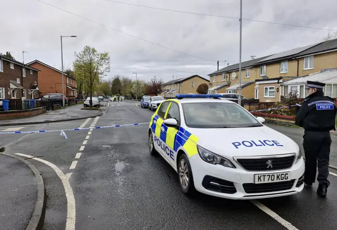 Police at the scene in the Moss Side area of Manchester