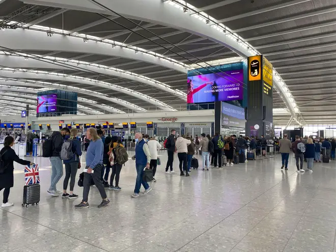 Passengers queuing to go through security in departures at Terminal 5 of Heathrow Airport