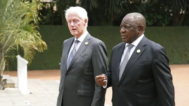 Ex-US president Bill Clinton and South African President Cyril Ramaphosa arrive to lay a wreath at a memorial in Kigali