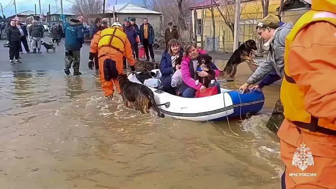 Emergency workers rescue local residents and their pets in Orsk, Russia