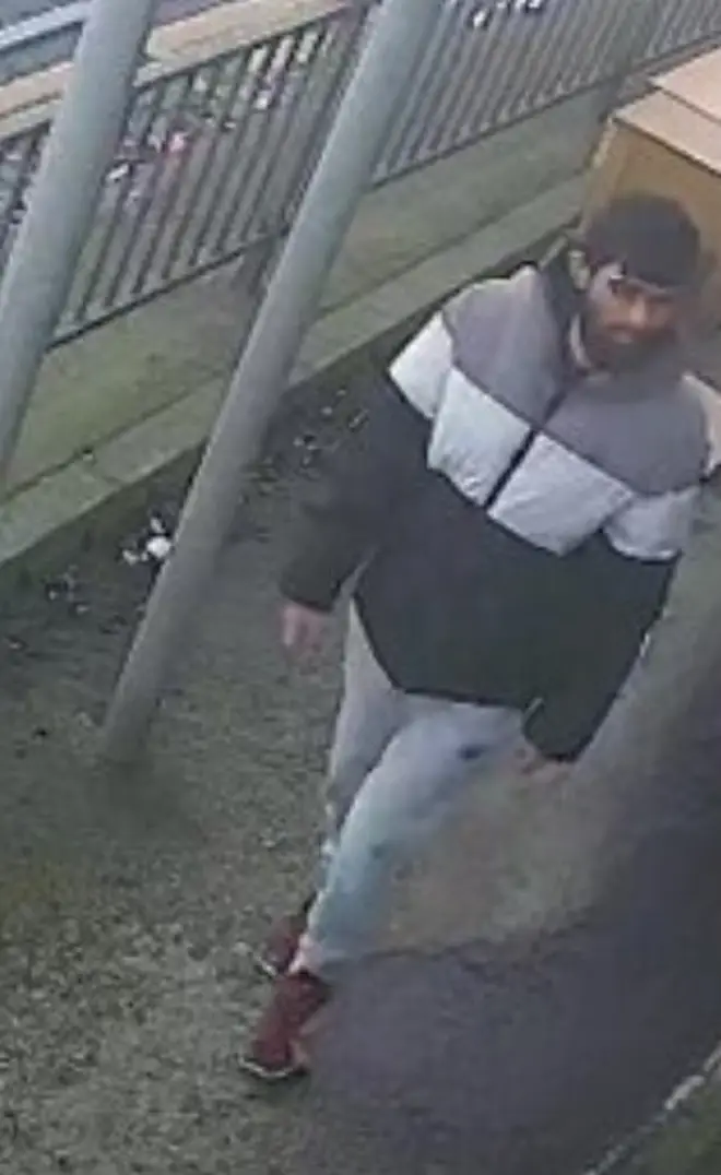 He was pictured on CCTV wearing a duffle coat with three large horizontal lines of grey, white and black, light blue or grey tracksuit bottoms with a small black emblem on the left pocket and maroon trainers.