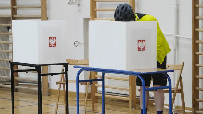 A man casts his ballot during local elections in Warsaw, Poland