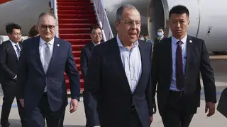 Russian foreign minister Sergey Lavrov, centre, walks from the plane upon his arrival in Beijing, China