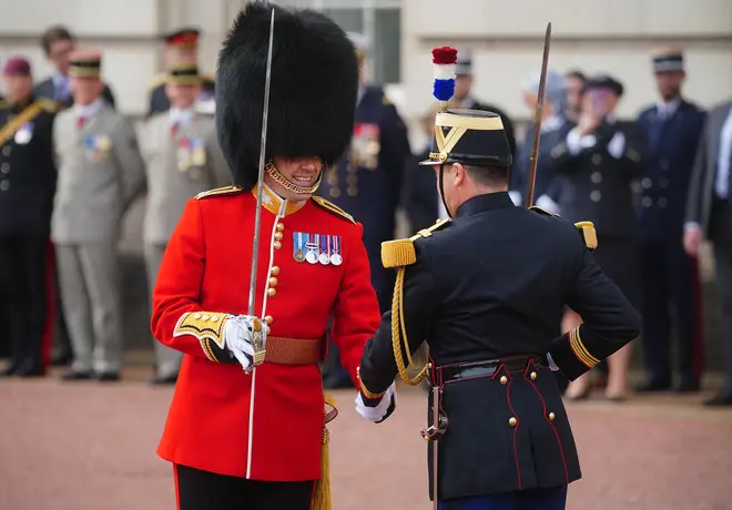 Members of France's Gendarmerie Garde Republicaine and members of the British Army's F Company Scots Guards take part in a special Changing of the Guard ceremony stand on duty at Buckingham Palace to mark the 120th anniversary of the Entente Cordiale.