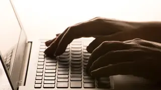 Hands on a laptop