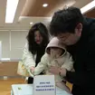 A family casts votes at a polling station in Seoul