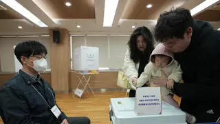 A family casts votes at a polling station in Seoul