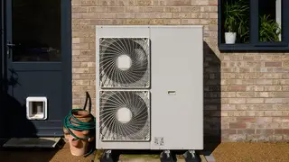 A domestic air source heat pump outside a back door
