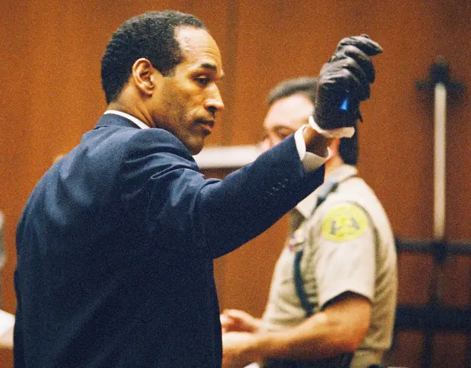 OJ Simpson trying on the gloves which were allegedly worn by the person who committed the murders.