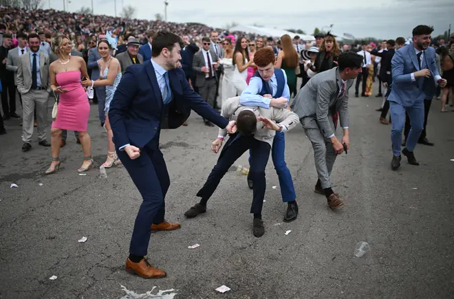 Racegoers fight each other as they scuffle on the second day of the Grand National Festival horse race meeting at Aintree Racecourse in Liverpool