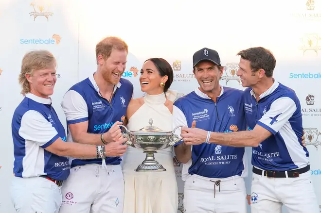 Meghan presented Harry's team with a trophy.