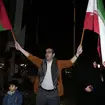 A demonstrator waves Iranian and Palestinian flags during an anti-Israeli gathering at the Felestin (Palestine) Square in Tehran, Iran