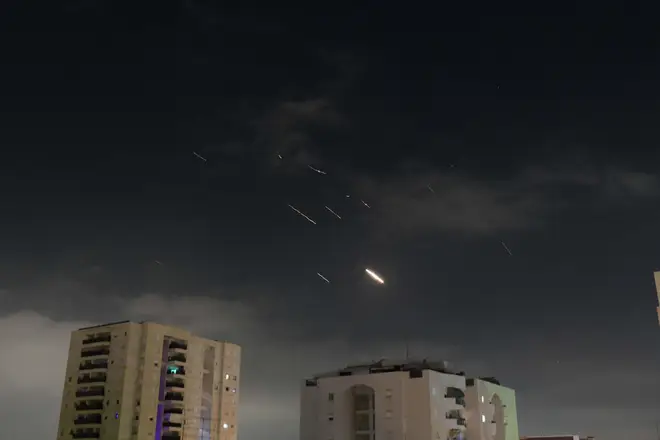 This photo taken on April 14, 2024 shows flares from explosions in the sky over Tel Aviv as Israel's anti-missile system intercepts missiles and drones from Iran
