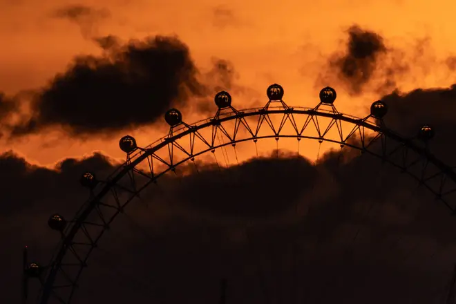 London, UK. 13th April 2024. UK Weather: Dramatic sunset near London Eye ferris wheel ending a warm Saturday which the Met Office confirms as hottest day of the year