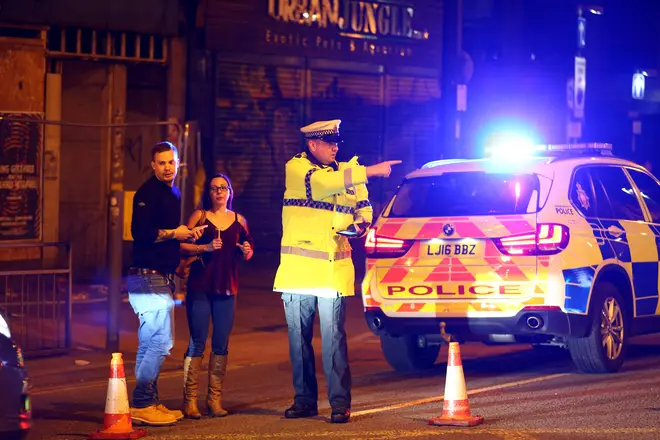 Police stand by a cordoned off street close to the Manchester Arena on May 22, 2017