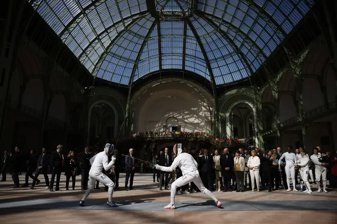 French President Emmanuel Macron attends a demonstration by the French fencing team as he visits the Grand Palais in Paris