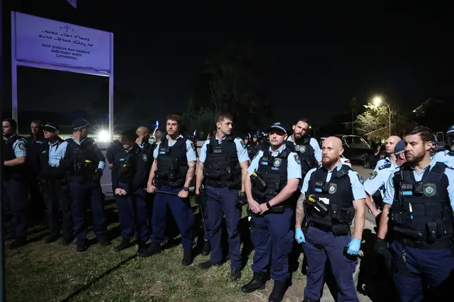 New South Wales police guard the perimeter of the Christ the Good Shepherd Church in Sydney's western suburb of Wakeley