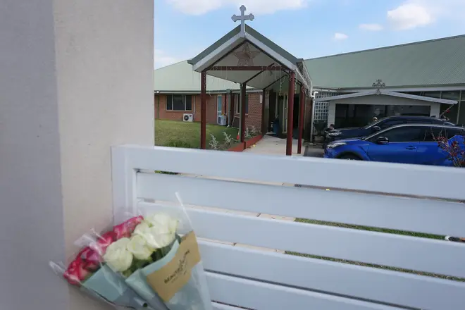 Flowers left against a fence at Christ The Good Shepherd Church after the attack