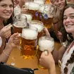 Women with glasses of beer pose for a photo on day one of the 188th Oktoberfest’beer festival in Munich, Germany, in 2023