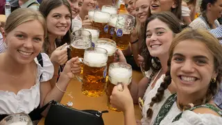 Women with glasses of beer pose for a photo on day one of the 188th Oktoberfest’beer festival in Munich, Germany, in 2023