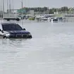 Vehicles abandoned in floodwater on a major road in Dubai