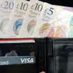 A wallet containing bank cards and notes