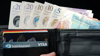 A wallet containing bank cards and notes