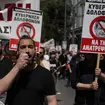 A protester uses a loudhailer during a rally in Athens
