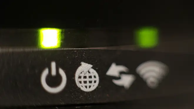 The lights on the front panel of a broadband internet router, London.