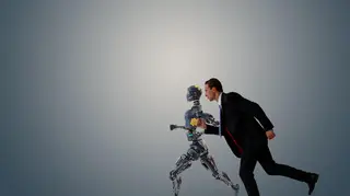 Businessman racing with a robot