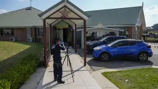 A police forensic officer at the Christ the Good Shepherd church in suburban Wakely in western Sydney, Australia