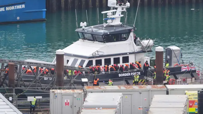 A group of people thought to be migrants are brought in to Dover, Kent.
