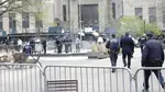 Paramedics attend to a person who lit themselves on fire near Manhattan Criminal Court
