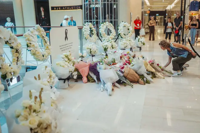 Flowers left inside the Westfield shopping centre in Bondi Junction, Sydney, where the stabbing took place