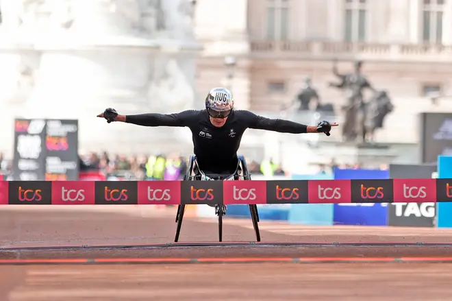 Marcel Hug of Switzerland crosses the finish line to win the men's wheelchair race