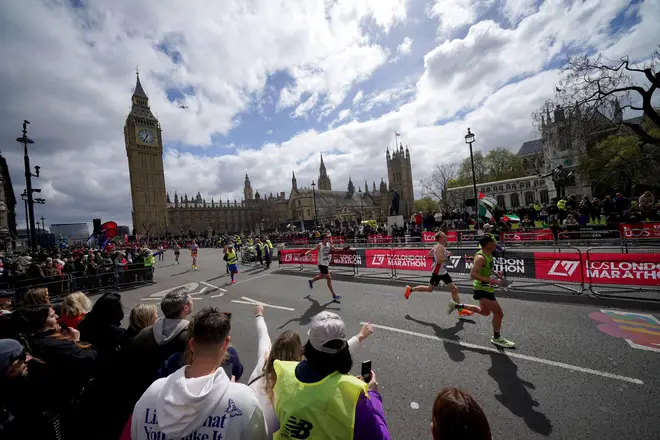 Competitors run past Westminster in the 2023 London Marathon