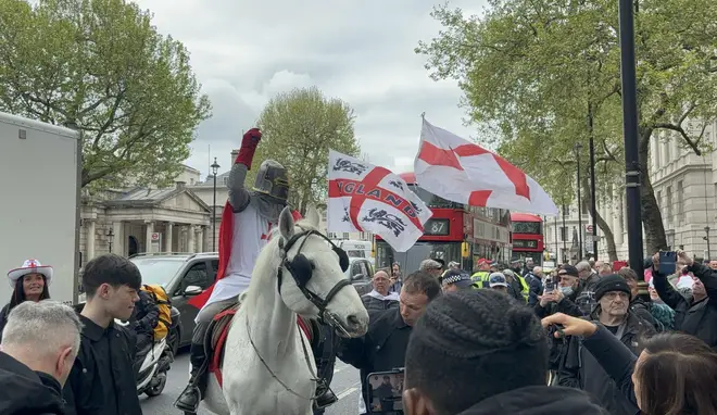 A man dressed as St George riding a horse on Whitehall