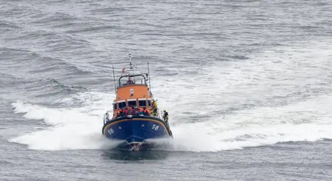 A group of people thought to be migrants are brought in to Dover, Kent, onboard the RNLI Dover Lifeboat