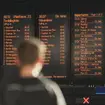 A passenger looks at the travel boards