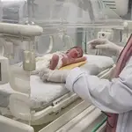 A Palestinian baby girl, Sabreen Jouda, who was delivered prematurely after her mother was killed in an Israeli strike, lies in an incubator in the Emirati hospital