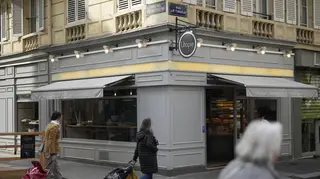 Parisians walk by the Utopie bakery in Paris