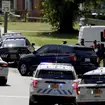 Multiple law enforcement vehicles respond in the neighborhood where several officers on a task force trying to serve a warrant were shot