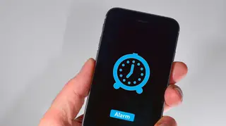An alarm symbol on an Apple iPhone