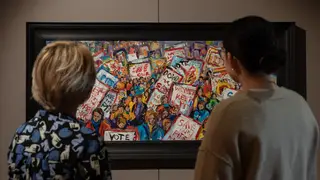People look at a painting in the new Last Cage Down exhibition at the Mining Art Gallery
