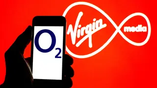 The Virgin Media logo with the O2 logo on a smartphone in the foreground